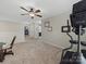 Spacious upstairs hallway with neutral walls, a ceiling fan, and home gym equipment at 807 Oak Manor Se Dr, Concord, NC 28025