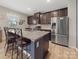 Open kitchen features stainless steel appliances, granite countertops and dark wood cabinetry at 807 Oak Manor Se Dr, Concord, NC 28025