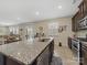Granite kitchen island with stainless sink, dark wood cabinetry and stainless appliances at 807 Oak Manor Se Dr, Concord, NC 28025
