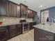 Modern kitchen boasts stainless steel appliances, granite countertops and wooden cabinets at 807 Oak Manor Se Dr, Concord, NC 28025