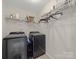 Modern laundry room with gray washer and dryer units, and white wire shelving at 807 Oak Manor Se Dr, Concord, NC 28025