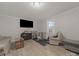 Cozy living room with a large tv, lots of seating and nice hardwood flooring at 807 Oak Manor Se Dr, Concord, NC 28025