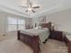 Spacious main bedroom featuring a trey ceiling, ceiling fan and large windows for natural light at 807 Oak Manor Se Dr, Concord, NC 28025