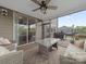 Covered porch with plush seating, string lights, ceiling fan and an outdoor grill at 807 Oak Manor Se Dr, Concord, NC 28025