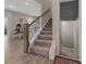Carpeted staircase with white banister leading to a lower level and view of dining area at 807 Oak Manor Se Dr, Concord, NC 28025