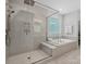 Elegant bathroom featuring a glass-enclosed shower, a luxurious soaking tub, and sleek tile work at 811 Penny Royal Ave, Fort Mill, SC 29715