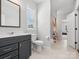 Bathroom featuring a dark vanity, toilet, shower with curtain, and window at 811 Penny Royal Ave, Fort Mill, SC 29715