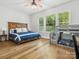 Bright bedroom featuring a large bed, a bunk bed, and hardwood floors at 811 Penny Royal Ave, Fort Mill, SC 29715
