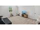 Cozy bonus room with a TV, comfortable seating, and neutral carpet creating a versatile space at 811 Penny Royal Ave, Fort Mill, SC 29715