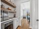 Butler pantry with open shelving, beverage fridge and view of dining room at 811 Penny Royal Ave, Fort Mill, SC 29715