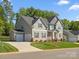 Charming two-story home with a three-car garage, well-kept lawn, and inviting curb appeal at 811 Penny Royal Ave, Fort Mill, SC 29715