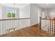 Bright hallway featuring hardwood floors, white trim, large window, and modern lighting fixture at 811 Penny Royal Ave, Fort Mill, SC 29715