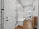 Well-designed hallway featuring a bench, stylish wallpaper, and access to the bathroom at 811 Penny Royal Ave, Fort Mill, SC 29715