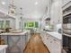 Well-lit kitchen featuring an island with a sink, stainless steel appliances, and ample cabinet space at 811 Penny Royal Ave, Fort Mill, SC 29715