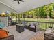 Inviting screened porch featuring comfortable seating, ceiling fan, and views of the serene backyard at 811 Penny Royal Ave, Fort Mill, SC 29715