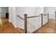Classic staircase with hardwood steps, white railings, and decorative wood posts leading to the upper level at 811 Penny Royal Ave, Fort Mill, SC 29715