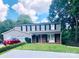 Charming two-story home with a well-maintained lawn, mature trees, and classic architectural details at 9404 Robert Burns Ct, Charlotte, NC 28213