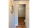 Hallway leading to the closet space with sleek hardwood floors and neutral walls giving a clean, modern look at 9404 Robert Burns Ct, Charlotte, NC 28213