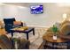 Inviting living room with comfortable seating, a wooden coffee table, and a large screen TV for entertainment at 9404 Robert Burns Ct, Charlotte, NC 28213