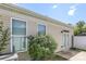 Exterior featuring two windows and a door leading to the backyard at 101 N Ferncliff Dr, Mount Holly, NC 28120