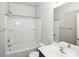 Well-lit bathroom features a shower and tub combination with modern fixtures at 101 N Ferncliff Dr, Mount Holly, NC 28120