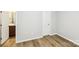 Bedroom with wood-look floors and view into the ensuite bathroom at 101 N Ferncliff Dr, Mount Holly, NC 28120