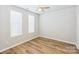 Bright bedroom with a ceiling fan and wood-look floors, bathed in natural light at 101 N Ferncliff Dr, Mount Holly, NC 28120