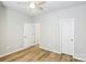 Bedroom with neutral walls and wood-look floors and view into hall at 101 N Ferncliff Dr, Mount Holly, NC 28120