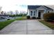 Paved driveway to home with manicured lawn and green bushes at 101 N Ferncliff Dr, Mount Holly, NC 28120