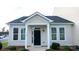 Inviting home entrance with black door, white pillars and trim, and well-maintained landscaping at 101 N Ferncliff Dr, Mount Holly, NC 28120