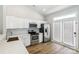 Modern kitchen features stainless steel appliances, white cabinets, and a window with a view at 101 N Ferncliff Dr, Mount Holly, NC 28120