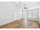 Spacious living room featuring vaulted ceilings, light walls, and wood-look floors at 101 N Ferncliff Dr, Mount Holly, NC 28120