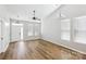 Spacious living room featuring vaulted ceilings, light walls, and wood-look floors at 101 N Ferncliff Dr, Mount Holly, NC 28120