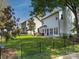 Spacious backyard featuring a well-maintained lawn, mature trees, and a stylish patio with outdoor seating at 103 Claremont Way, Mooresville, NC 28117
