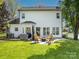 Inviting backyard featuring a stone patio, comfortable seating, and a lush green lawn, perfect for outdoor enjoyment at 103 Claremont Way, Mooresville, NC 28117
