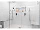 Stunning bathroom showcasing dual shower heads, seating, and a built-in niche for toiletries within a modern, tiled space at 103 Claremont Way, Mooresville, NC 28117