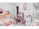 Vibrant bedroom features fun, colorful decorations, a charming dollhouse, and ample storage space at 103 Claremont Way, Mooresville, NC 28117