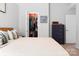 Bedroom featuring warm neutral colors, walk-in closet, and a dark wood dresser at 103 Claremont Way, Mooresville, NC 28117