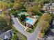 Aerial view of a community pool, tennis court, and playground, offering recreational amenities for residents at 103 Claremont Way, Mooresville, NC 28117