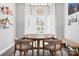 Cozy dining area with a round table, chairs, light fixture and a large window providing natural light at 103 Claremont Way, Mooresville, NC 28117