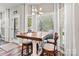 Bright breakfast nook with a wooden table, stylish chairs, and large windows at 103 Claremont Way, Mooresville, NC 28117