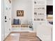 Inviting entryway with a bench, storage baskets, shelving, and hardwood floors offering a stylish and functional space at 103 Claremont Way, Mooresville, NC 28117