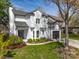 Charming two-story home featuring white siding, a well-manicured lawn, an attached garage, and tasteful landscaping at 103 Claremont Way, Mooresville, NC 28117