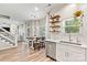 Bright kitchen featuring modern stainless steel appliances, an eat-in dining table, and stylish floating shelves at 103 Claremont Way, Mooresville, NC 28117