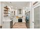 Stylish kitchen with stainless steel appliances, white cabinets and light wood-look floors at 103 Claremont Way, Mooresville, NC 28117
