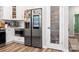 Kitchen featuring stainless steel appliances, light cabinetry, and a frosted pantry door at 103 Claremont Way, Mooresville, NC 28117