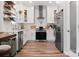 Bright kitchen with stainless steel appliances, white cabinetry, and wood-look flooring at 103 Claremont Way, Mooresville, NC 28117