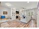Bright living room with a fireplace, built-in shelving and bench, and wood flooring at 103 Claremont Way, Mooresville, NC 28117
