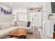 Open-concept living room showcasing a comfortable sofa, stylish coffee table, and seamless flow to other areas at 103 Claremont Way, Mooresville, NC 28117