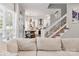 Modern living room featuring seamless flow into the kitchen and an open staircase, offering a contemporary feel at 103 Claremont Way, Mooresville, NC 28117